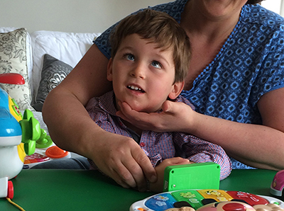 Therapeutic handling of boy with movement disorder in sitting